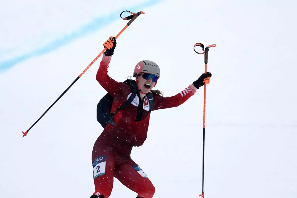 Switzerland's Marianne Fatton celebrates winning a ski mountaineering women's final at the 2026 Winter Olympics, in Bormio, Italy, Thursday, Feb. 19, 2026. (AP Photo/Gabriele Facciotti)