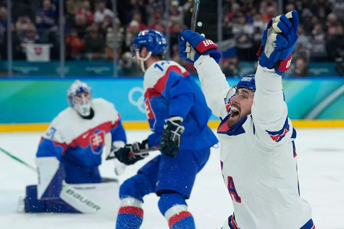 United States' Dylan Larkin (21) celebrates after scoring the opening goal during a men's ice hockey semifinal game between United States and Slovakia at the 2026 Winter Olympics, in Milan, Italy, Friday, Feb. 20, 2026. (AP Photo/Petr David Josek)