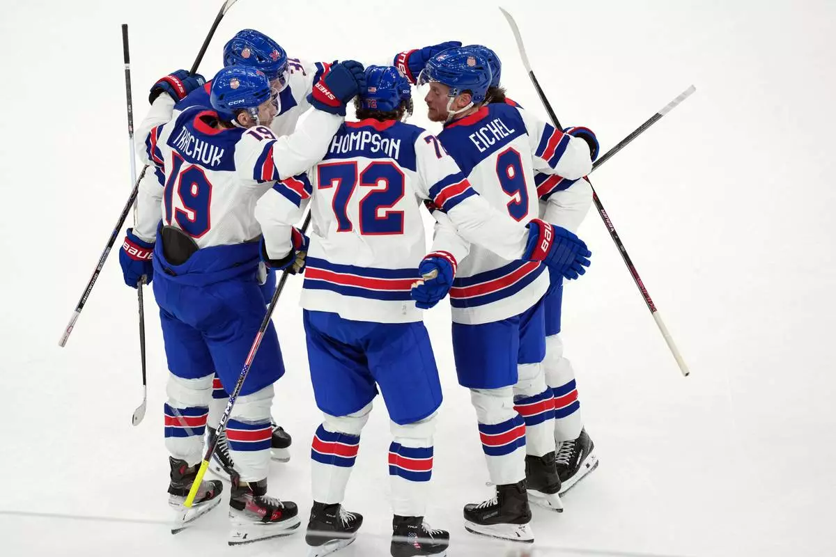 United States' Tage Thompson (72) celebrates with Matthew Tkachuk (19) and Jack Eichel (9) after Thompson scored against Slovakia during the first period of a men's ice hockey semifinal game at the 2026 Winter Olympics in Milan, Italy, Friday, Feb. 20, 2026. (AP Photo/Carolyn Kaster)