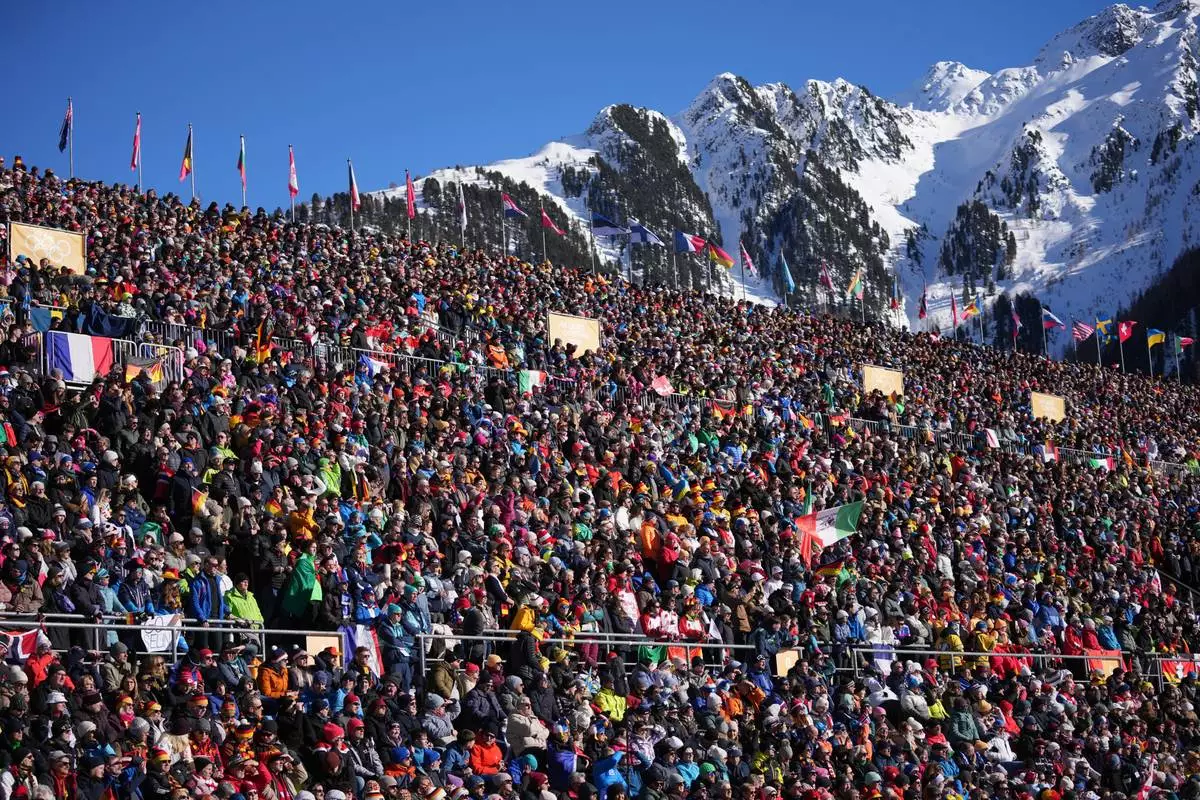 Spectators watch the start of the women's 10-kilometer pursuit biathlon race at the 2026 Winter Olympics in Anterselva, Italy, Sunday, Feb. 15, 2026. (AP Photo/Andrew Medichini)