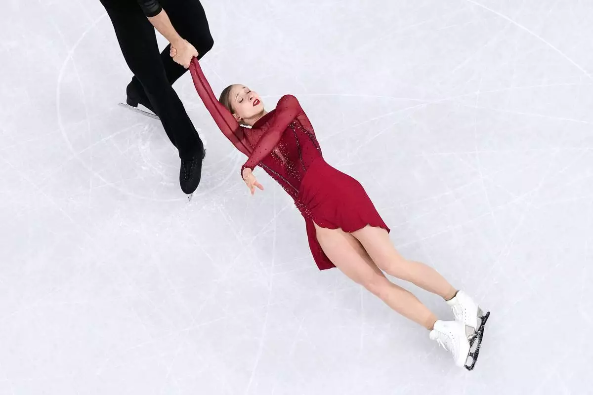 Minerva Fabienne Hase and Nikita Volodin of Germany compete during the pairs figure skating short program at the 2026 Winter Olympics, in Milan, Italy, Sunday, Feb. 15, 2026. (AP Photo/Bernat Armangue)