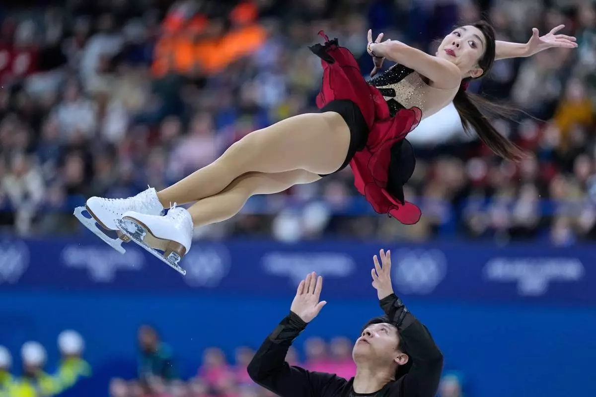 Sui Wenjing and Han Cong of China compete during the pairs figure skating short program at the 2026 Winter Olympics, in Milan, Italy, Sunday, Feb. 15, 2026. (AP Photo/Natacha Pisarenko)