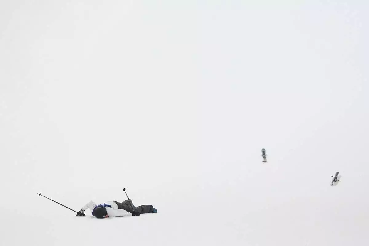 Finland's Elias Lajunen crashes during the men's freestyle skiing big air qualifications at the 2026 Winter Olympics, in Livigno, Italy, Sunday, Feb. 15, 2026. (AP Photo/Lindsey Wasson)