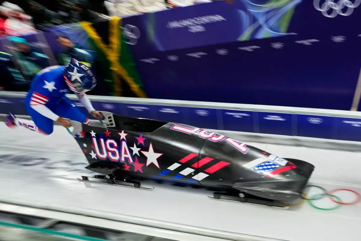 United States' Elana Meyers Taylor starts for a women's monobob run at the 2026 Winter Olympics, in Cortina d'Ampezzo, Italy, Sunday, Feb. 15, 2026. (AP Photo/Aijaz Rahi)