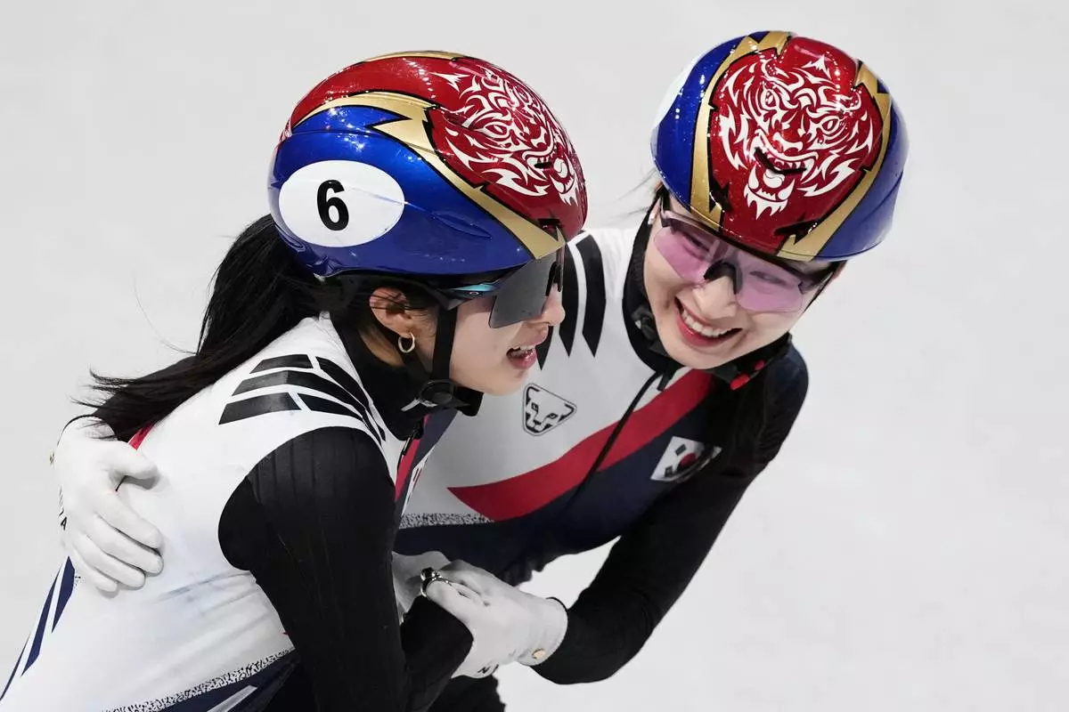Kim Gilli and Choi Minjeong of Team Korea celebrate after winning gold during the short track speed skating women's team 3000m relay at the 2026 Winter Olympics, in Milan, Italy, Wednesday, Feb. 18, 2026. (AP Photo/Francisco Seco)