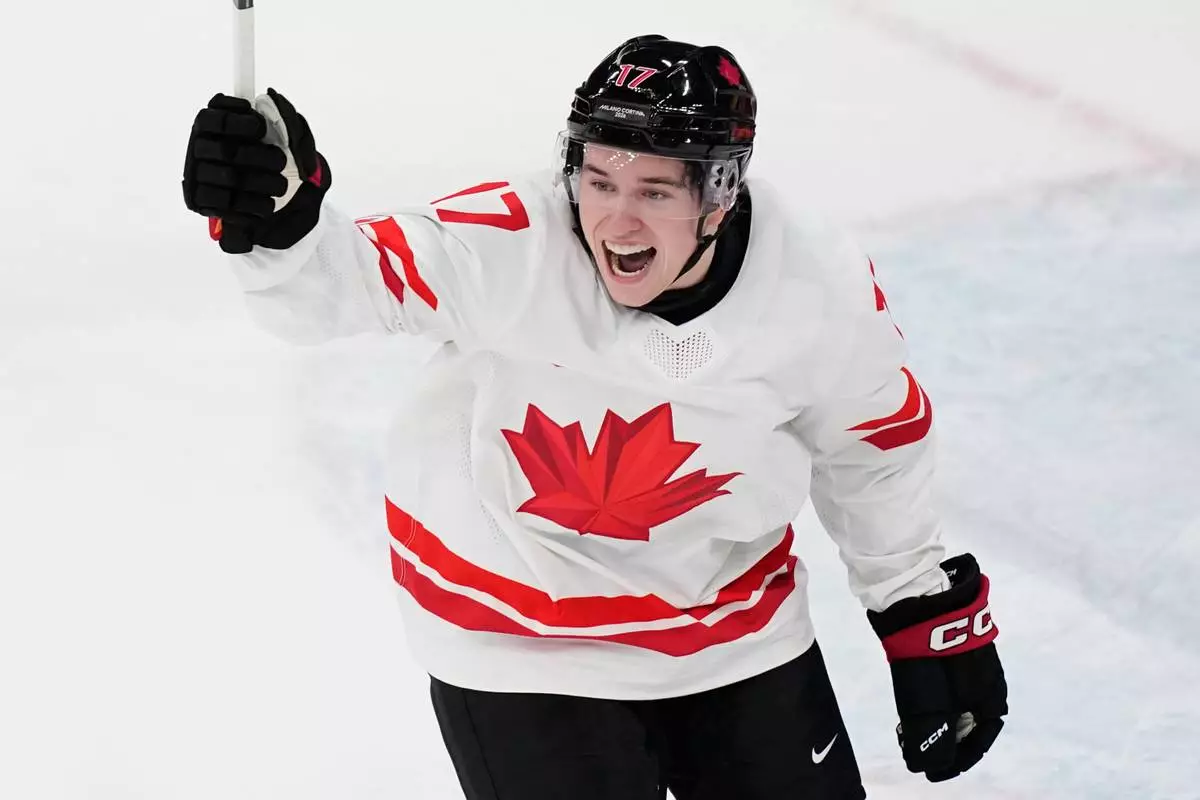 Canada's Macklin Celebrini celebrates after scoring his sides first goal during a preliminary round match of men's ice hockey between Czech Republic and Canada at the 2026 Winter Olympics, in Milan, Italy, Thursday, Feb. 12, 2026. (AP Photo/Petr David Josek)