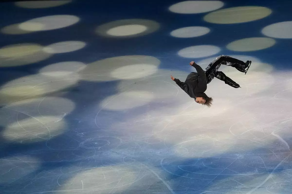 Ilia Malinin of the United States does a back flip during his performance in the figure skating exhibition at the 2026 Winter Olympics, in Milan, Italy, Saturday, Feb. 21, 2026. (AP Photo/Francisco Seco)