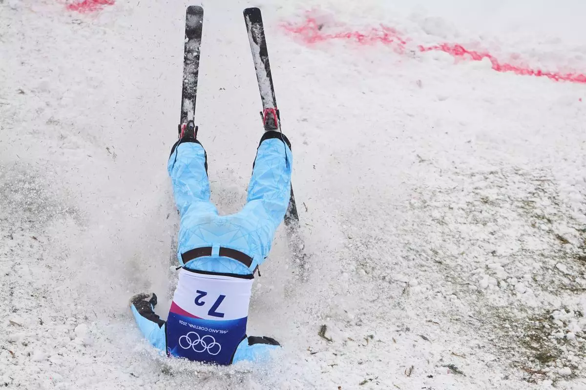 Kazakhstan's Roman Ivanov (7-2) crashes during the freestyle skiing mixed team aerials final at the 2026 Winter Olympics, in Livigno, Italy, Saturday, Feb. 21, 2026. (AP Photo/Lindsey Wasson)