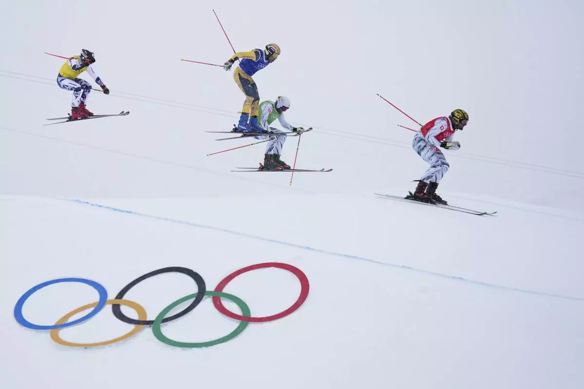 From left, Czechia's Daniel Paulus (27), Germany's Florian Fischer (14), Switzerland's Alex Fiva (11) and Switzerland's Ryan Regez (3) compete during the men's ski cross final at the 2026 Winter Olympics, in Livigno, Italy, Saturday, Feb. 21, 2026. (AP Photo/Abbie Parr)