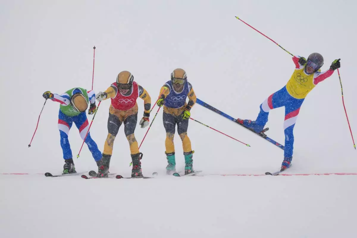 From left, France's Terence Tchiknavorian (12), Germany's Florian Wilmsmann (4), Germany's Cornel Renn (20) and France's Youri Duplessis-Kergomard (21) compete during the men's ski cross final at the 2026 Winter Olympics, in Livigno, Italy, Saturday, Feb. 21, 2026. (AP Photo/Julia Demaree Nikhinson)