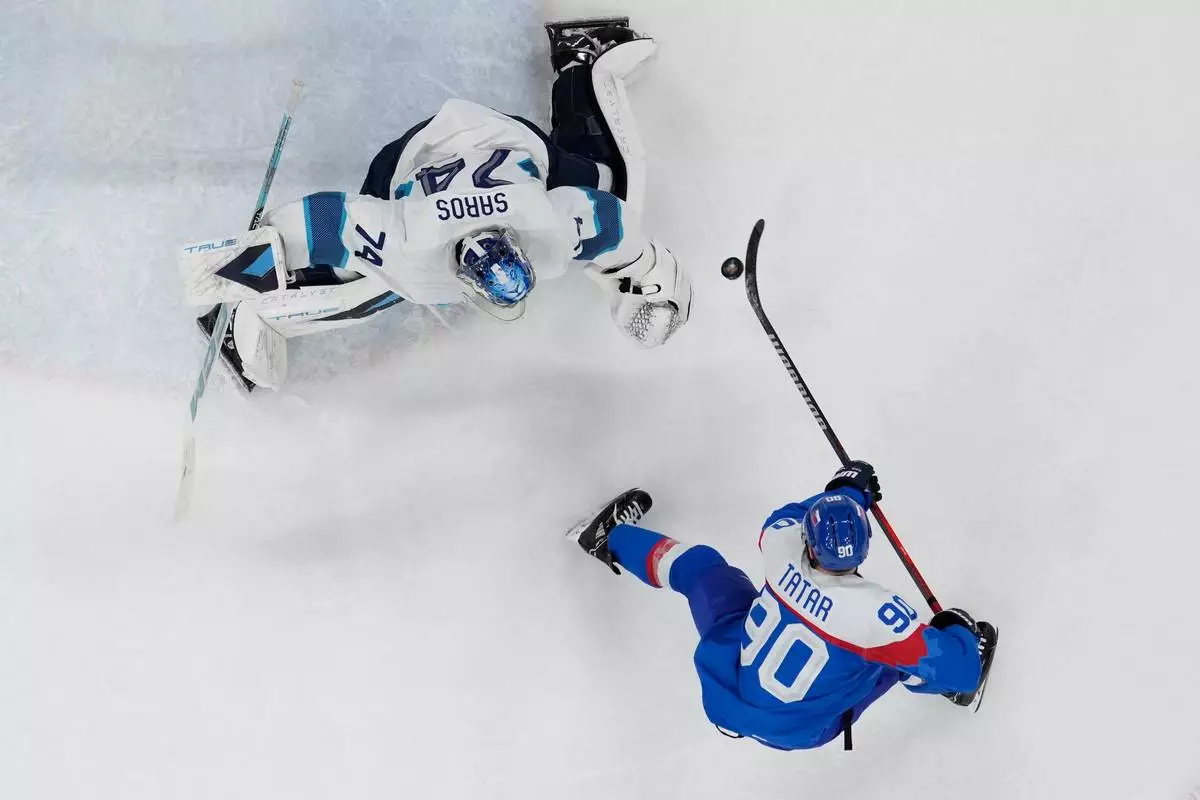 Slovakia's Tomas Tatar (90) scores his side's opening goal during a men's ice hockey bronze medal game between Slovakia and Finland at the 2026 Winter Olympics, in Milan, Italy, Saturday, Feb. 21, 2026. (AP Photo/Petr David Josek)