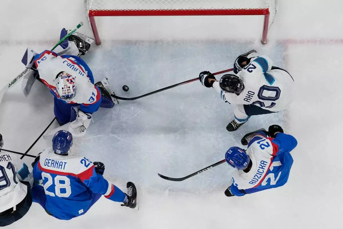 Finland's Sebastian Aho (20) scores his side's opening goal during a men's ice hockey bronze medal game between Slovakia and Finland at the 2026 Winter Olympics, in Milan, Italy, Saturday, Feb. 21, 2026. (AP Photo/Petr David Josek)