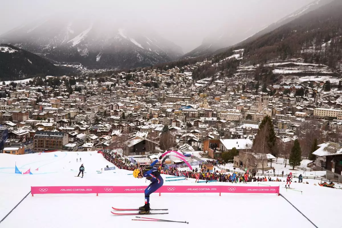 France's Thibault Anselmet strips off his skins during a ski mountaineering mixed relay, at the 2026 Winter Olympics, in Bormio, Italy, Saturday, Feb. 21, 2026. (AP Photo/Rebecca Blackwell)