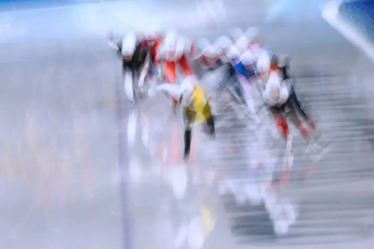 Athletes compete in the women's mass start semifinal speedskating races at the 2026 Winter Olympics, in Milan, Italy, Saturday, Feb. 21, 2026. (AP Photo/Luca Bruno)