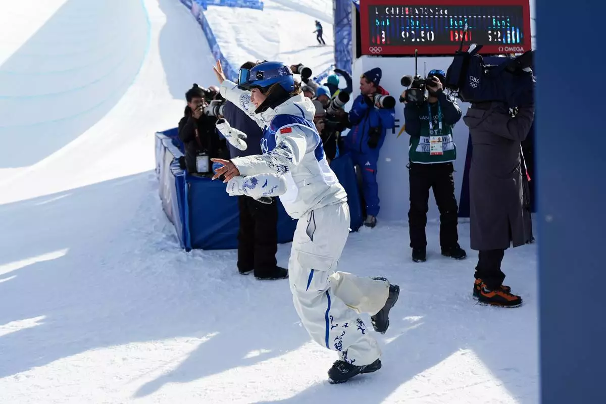 Gold medalist China's Eileen Gu reacts to winning the women's freestyle skiing halfpipe final at the 2026 Winter Olympics, in Livigno, Italy, Sunday, Feb. 22, 2026. (AP Photo/Abbie Parr)