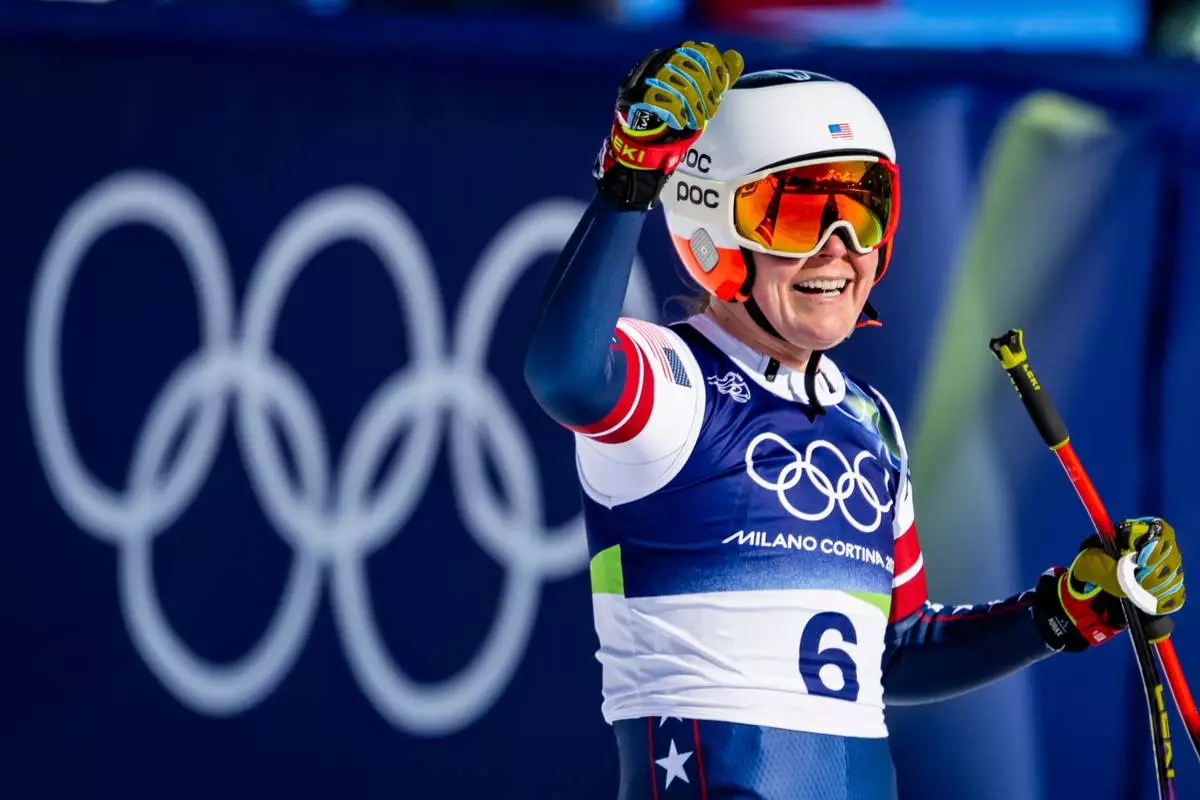 Breezy Johnson of the United States reacts in the finish area of the alpine ski women's downhill race, at the 2026 Winter Olympics, in Cortina d'Ampezzo, Italy, Sunday, Feb. 8, 2026. (Jean-Christophe Bott, Keystone via AP)
