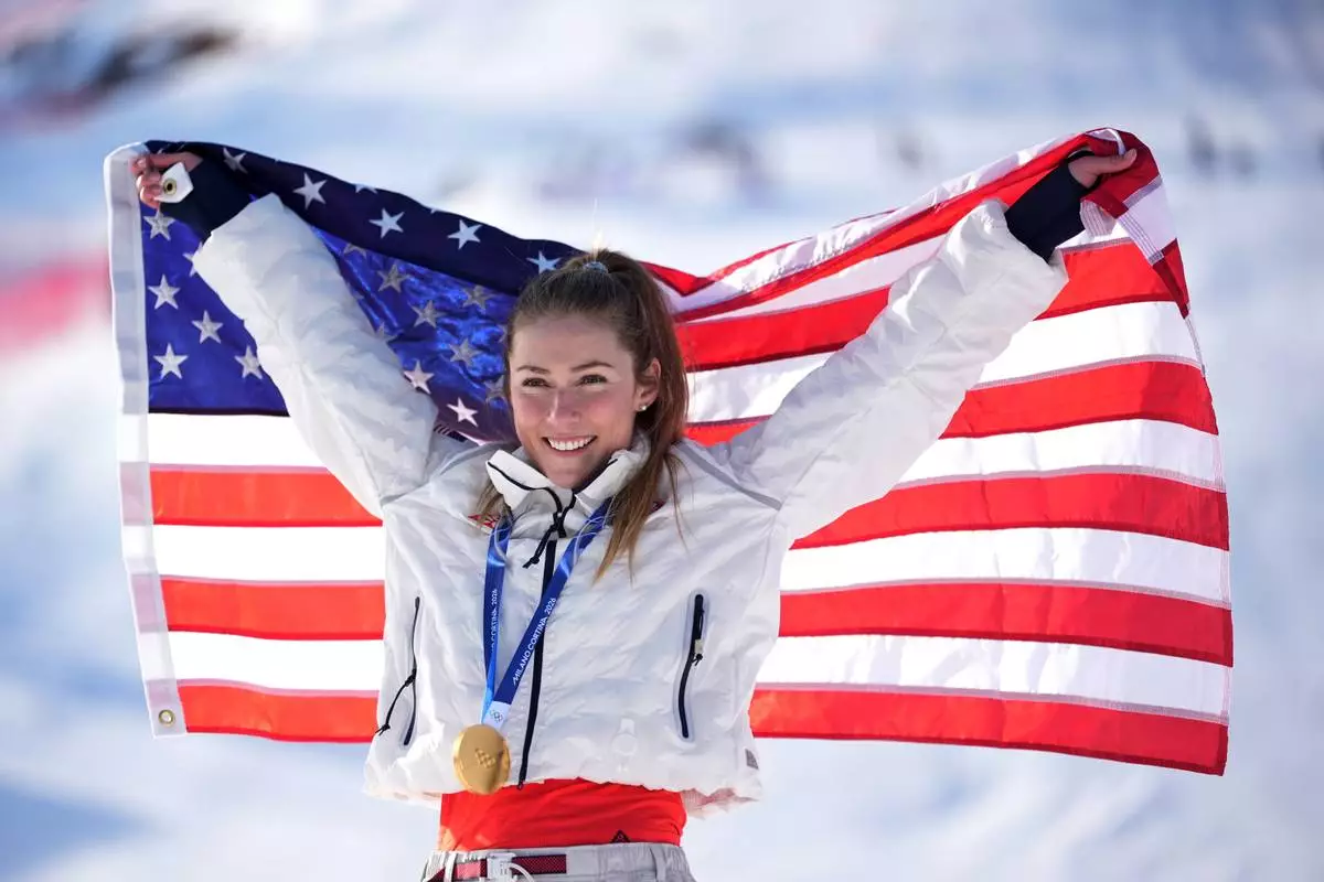 United States' Mikaela Shiffrin celebrates winning the gold medal in an alpine ski, women's slalom race, at the 2026 Winter Olympics, in Cortina d'Ampezzo, Italy, Wednesday, Feb. 18, 2026. (AP Photo/Jacquelyn Martin)