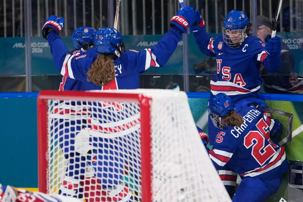 United States' Hilary Knight, right, celebrates with teammates after scoring her sides fourth goal during a preliminary round match of women's ice hockey between United States and Czechia at the 2026 Winter Olympics, in Milan, Italy, Thursday, Feb. 5, 2026. (AP Photo/Petr David Josek)