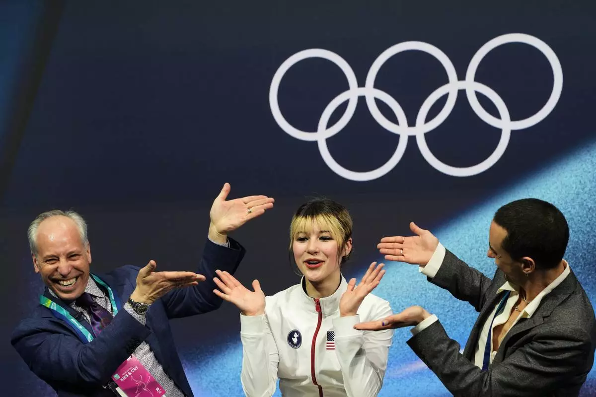 Alysa Liu of the United States reacts to her score after competing in the women's short program in figure skating at the 2026 Winter Olympics, in Milan, Italy, Tuesday, Feb. 17, 2026. (AP Photo/Natacha Pisarenko)