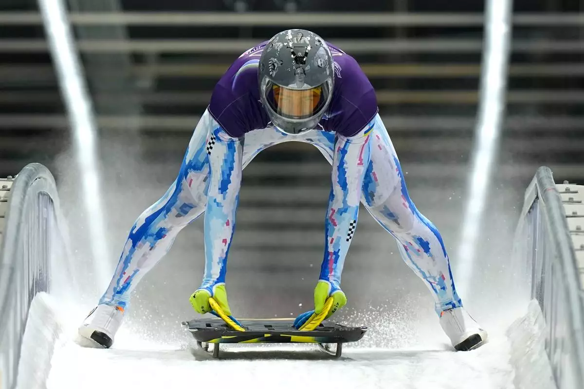 Ukraine's Vladyslav Heraskevych arrives at the finish during a men's skeleton training session at the 2026 Winter Olympics, in Cortina d'Ampezzo, Italy, Monday, Feb. 9, 2026. (AP Photo/Aijaz Rahi)