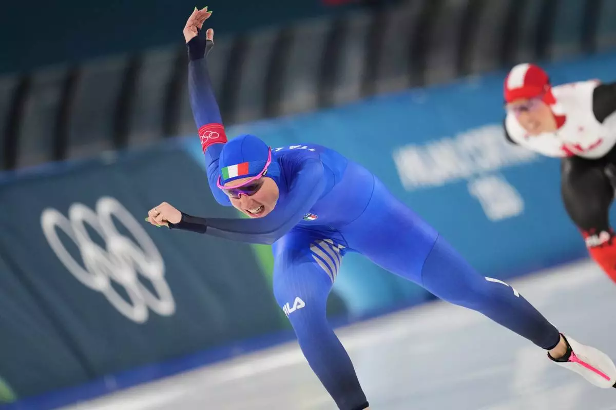 Francesca Lollobrigida of Italy, left, and Canada's Valerie Maltais, right, compete in the women's 3,000 meters speedskating race at the 2026 Winter Olympics, in Milan, Italy, Saturday, Feb. 7, 2026. (AP Photo/Christophe Ena)