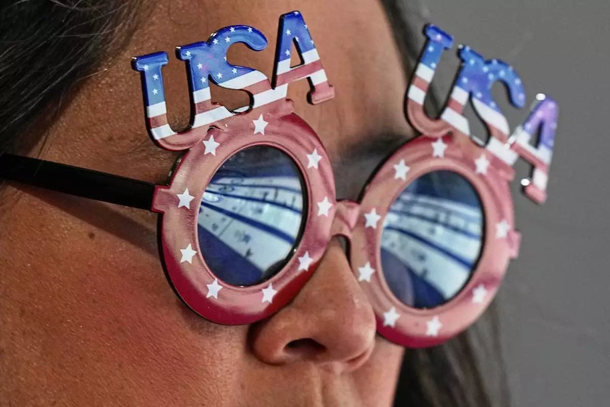 A United States supporter watches a women's curling semifinal match between Switzerland and the United States, at the 2026 Winter Olympics, in Cortina d'Ampezzo, Italy, Friday, Feb. 20, 2026. (AP Photo/Fatima Shbair)