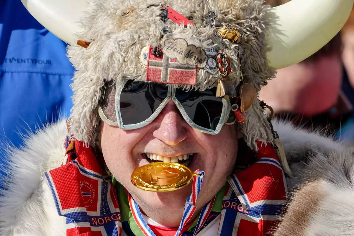 A Norway fan poses on the stands during the cross-country skiing men's and women's team sprint free events at the 2026 Winter Olympics, in Tesero, Italy, Wednesday, Feb. 18, 2026. (AP Photo/Matthias Schrader)