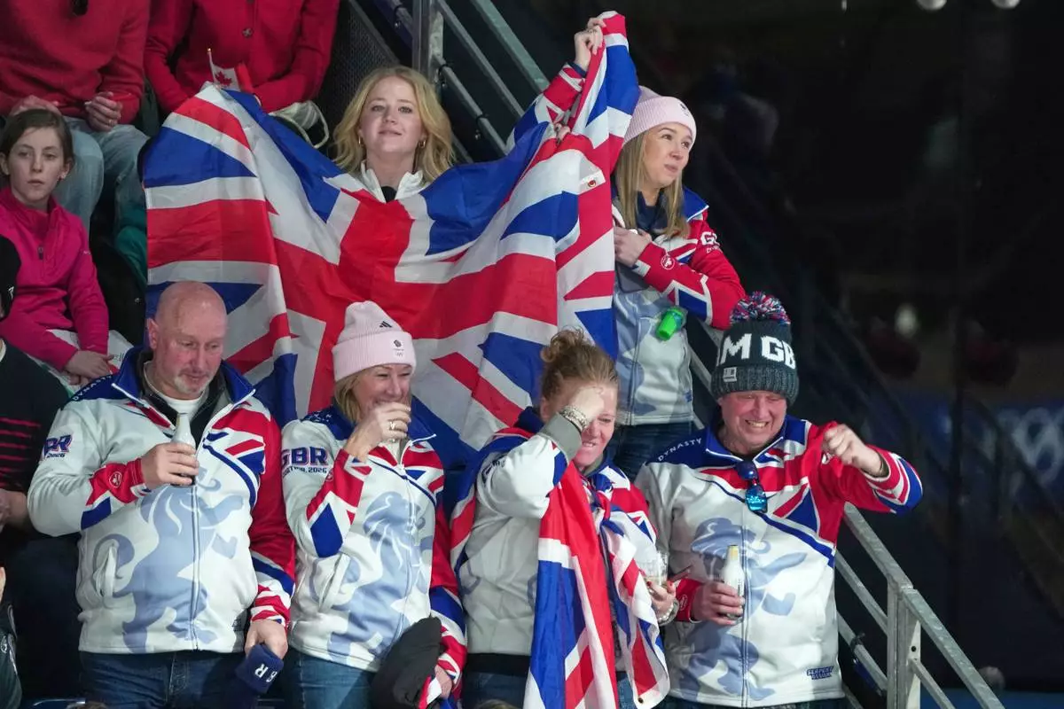 Britain fans watch the men's curling round robin session against the United States, at the 2026 Winter Olympics, in Cortina d'Ampezzo, Italy, Wednesday, Feb. 18, 2026. (AP Photo/Misper Apawu)