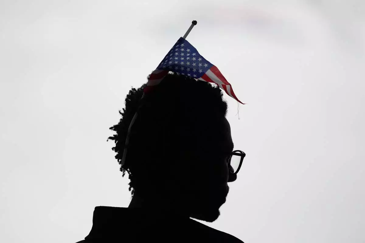 A fan watches the ice dancing free skate in figure skating at the 2026 Winter Olympics, in Milan, Italy, Wednesday, Feb. 11, 2026. (AP Photo/Francisco Seco)