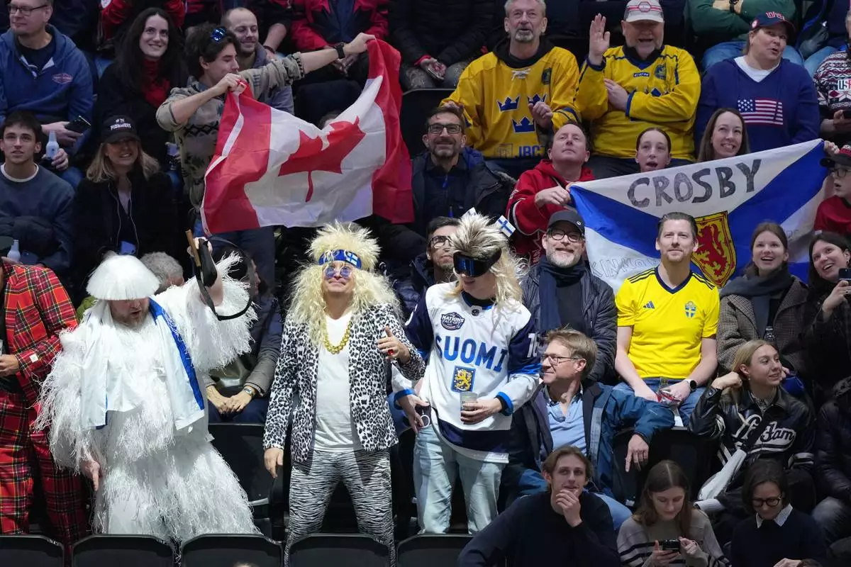 Fans wait for the start of a men's ice hockey semifinal game between Canada and Finland at the 2026 Winter Olympics in Milan, Italy, Friday, Feb. 20, 2026. (AP Photo/Carolyn Kaster)