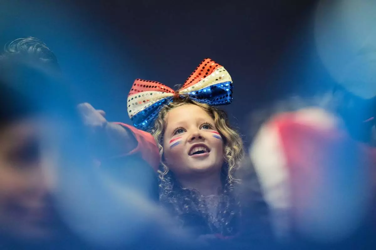 A fan cheers during the women's 1000 meter short track speed skating at the 2026 Winter Olympics, in Milan, Italy, Monday, Feb. 16, 2026. (AP Photo/Francisco Seco)