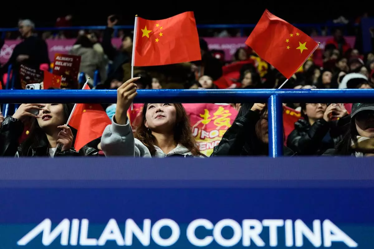 Fans wait for the short track speed skating men's 500m to start at the 2026 Winter Olympics, in Milan, Italy, Wednesday, Feb. 18, 2026. (AP Photo/Ashley Landis)