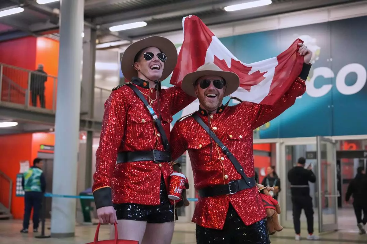 Fans who watched the Canadian women's team win the gold medal in the team pursuit speedskating race, celebrate at the 2026 Winter Olympics, in Milan, Italy, Tuesday, Feb. 17, 2026. (AP Photo/Ben Curtis)