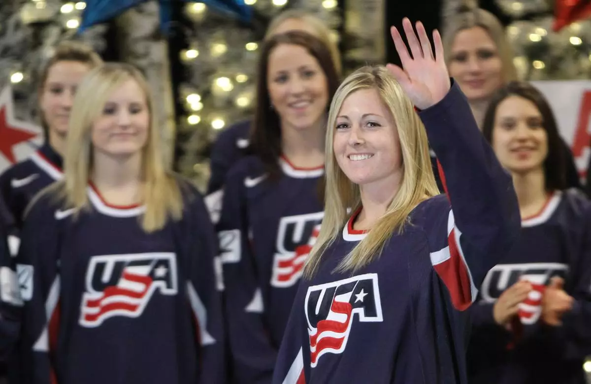 FILE - Gigi Marvin, of Warroad, Minn., waves as she is introduced as a member of the 2010 U.S. Olympic Women's Ice Hockey Team in Bloomington, Minn., Thursday, Dec. 17, 2009. (Bruce Bisping/Star Tribune via AP)