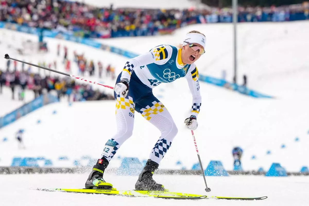 Frida Karlsson, of Sweden, reacts after crossing the finish line in the cross country skiing women's 10km interval start free at the 2026 Winter Olympics, in Tesero, Italy, Thursday, Feb. 12, 2026. (AP Photo/Kirsty Wigglesworth)