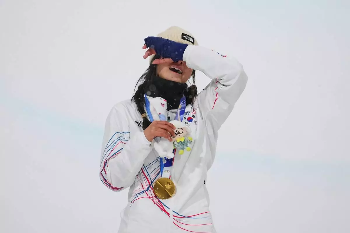Gold medalist South Korea's Choi Ga-on reacts on the podium after winning the women's snowboarding halfpipe finals at the 2026 Winter Olympics, in Livigno, Italy, Thursday, Feb. 12, 2026. (AP Photo/Lindsey Wasson)