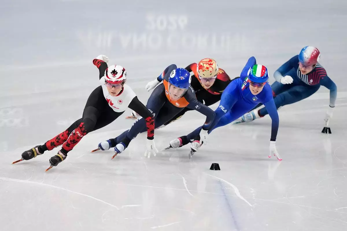 Courtney Sarault of Canada, Michelle Velzeboer of the Netherlands, and Elisa Confortola of Italy battle in the heats during the women's 1000 meter short track speed skating at the 2026 Winter Olympics, in Milan, Italy, Monday, Feb. 16, 2026. (AP Photo/Natacha Pisarenko)