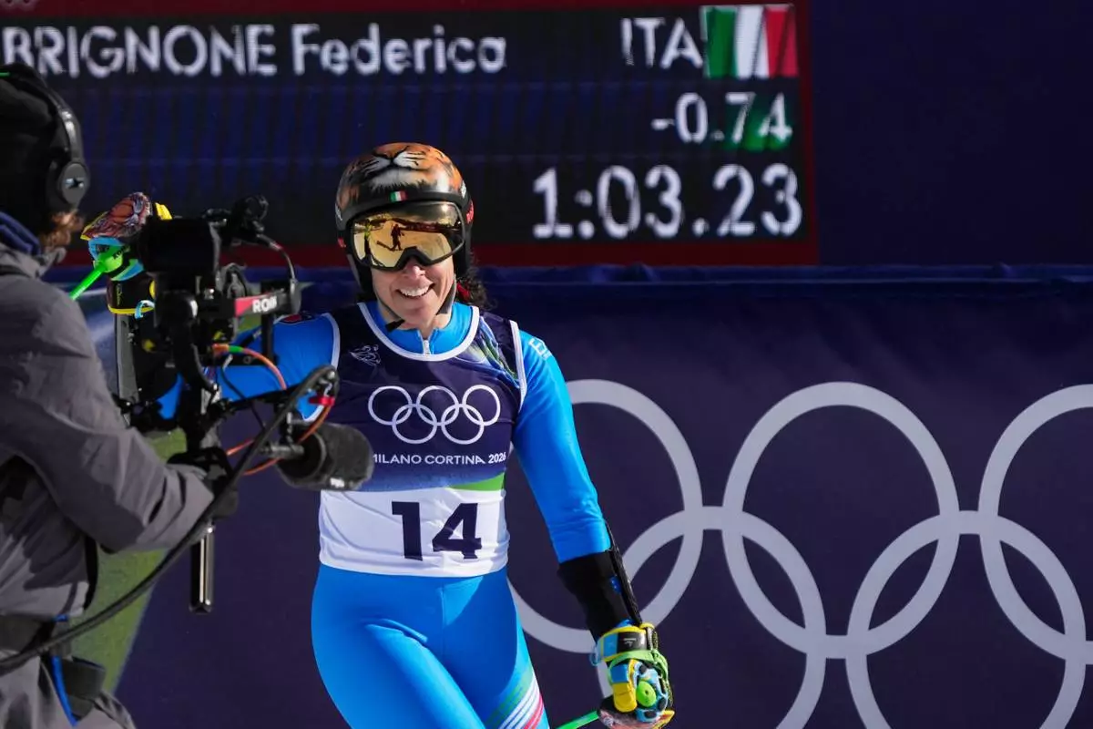 Italy's Federica Brignone at the finish area of an alpine ski, women's giant slalom race, at the 2026 Winter Olympics, in Cortina d'Ampezzo, Italy, Sunday, Feb. 15, 2026. (AP Photo/Andy Wong)