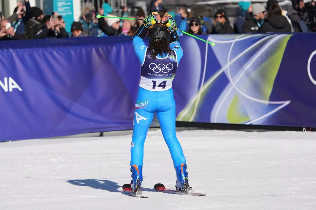 Italy's Federica Brignone celebrates at the finish area of an alpine ski, women's giant slalom race, at the 2026 Winter Olympics, in Cortina d'Ampezzo, Italy, Sunday, Feb. 15, 2026. (AP Photo/Jacquelyn Martin)