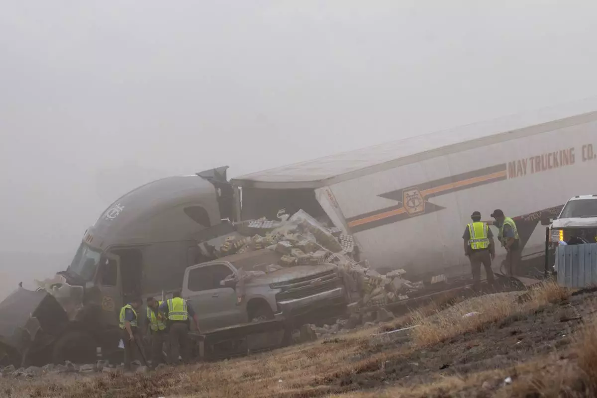 Emergency personnel work the scene of a crash involving 30-plus vehicles including six semi trucks on Interstate 25 south of Pueblo, Colo., on Tuesday, Feb. 17, 2026. (Christian Murdock/The Gazette via AP)