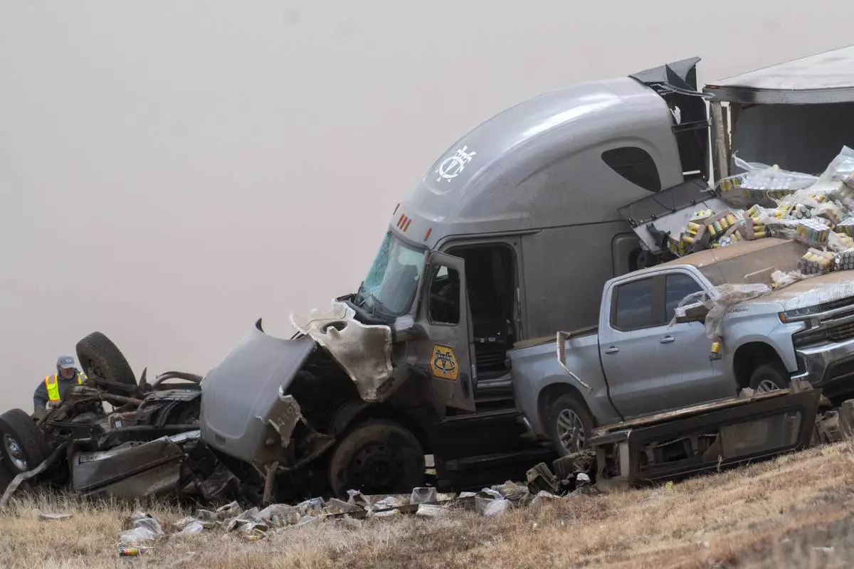 Emergency personnel work the scene of a crash involving 30-plus vehicles including six semi trucks on Interstate 25 south of Pueblo, Colo., on Tuesday, Feb. 17, 2026. (Christian Murdock/The Gazette via AP)