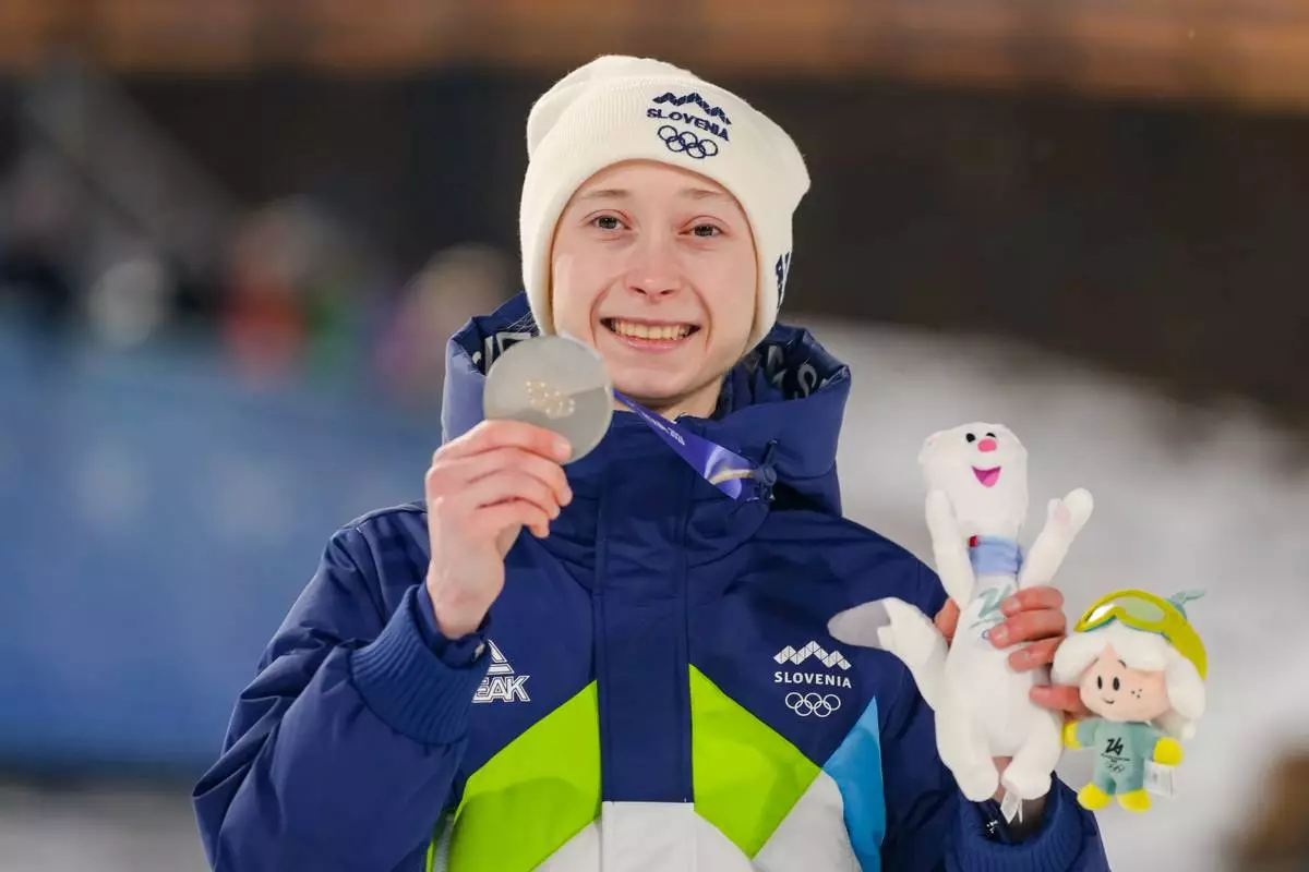 Nika Prevc, of Slovenia, poses after winning the silver medal in the ski jumping women's normal hill individual, at the 2026 Winter Olympics, in Predazzo, Italy, Saturday, Feb. 7, 2026. (AP Photo/Kirsty Wigglesworth)