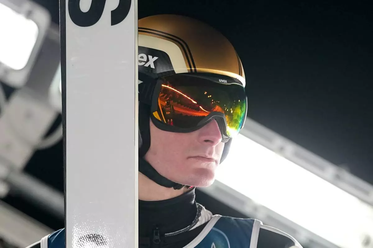 Domen Prevc, of Slovenia, waits his turn for a jump during a ski jumping, men's normal hill, training session, at the 2026 Winter Olympics, in Predazzo, Italy, Sunday, Feb. 8, 2026. (AP Photo/Matthias Schrader)