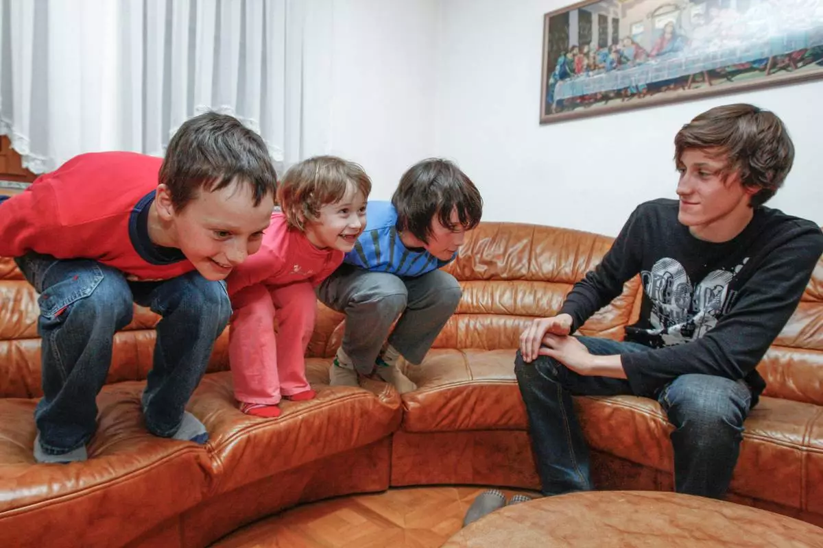 From left, Domen, Nika and Cene Prevc gesture as their older brother Peter looks on, in the living room of the Prevc family house, in Dolenja Vas village, in Slovenia, March, 22, 2010. (Gorazd Kavcic via AP)