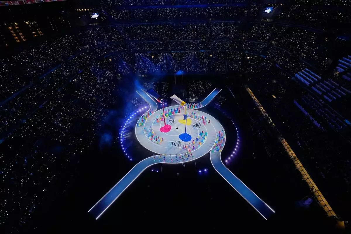 Entertainers perform during the Olympic opening ceremony at the 2026 Winter Olympics, in Milan, Italy, Friday, Feb. 6, 2026. (AP Photo/David J. Phillip)