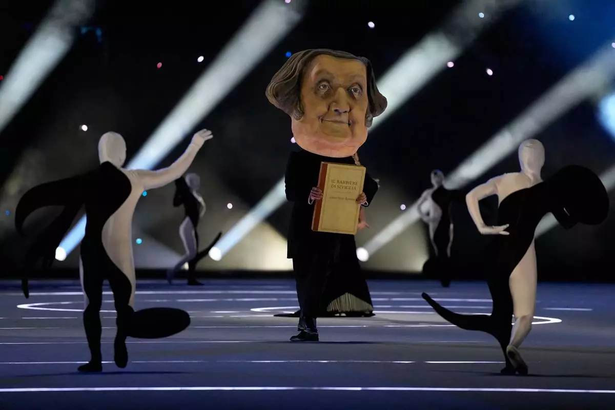 Dancers perform during the Olympic opening ceremony at the 2026 Winter Olympics, in Milan, Italy, Friday, Feb. 6, 2026. (AP Photo/Ashley Landis)