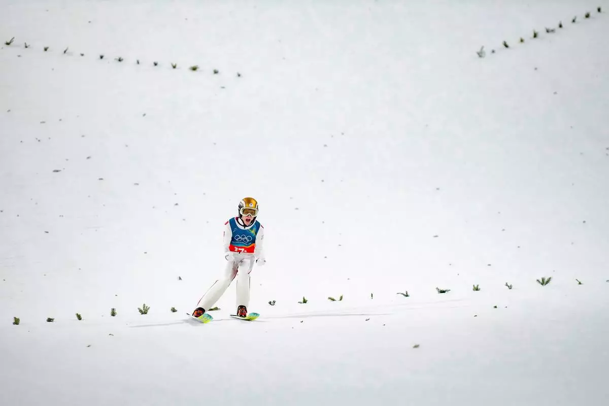 Jan Hoerl, of Austria, reacts after his final round jump of the ski jumping men's super team competition at the 2026 Winter Olympics, in Predazzo, Italy, Monday, Feb. 16, 2026. (AP Photo/Evgeniy Maloletka)