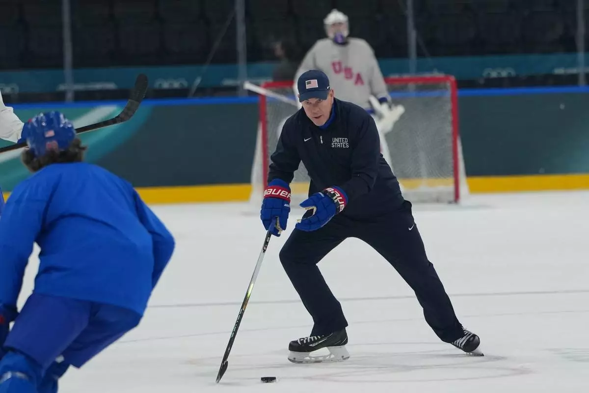 United States' head coach Mike Sullivan skies with the puck during men's ice hockey practice at the 2026 Winter Olympics, in Milan, Italy, Sunday, Feb. 8, 2026. (AP Photo/Carolyn Kaster)
