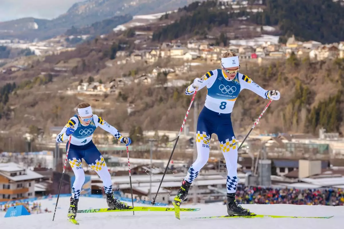 Frida Karlsson of Sweden, right, and Ebba Andersson also of Sweden, compete in the cross country skiing women's 10km + 10km skiathlon at the 2026 Winter Olympics, in Tesero, Italy, Saturday, Feb. 7, 2026. (AP Photo/Kirsty Wigglesworth)