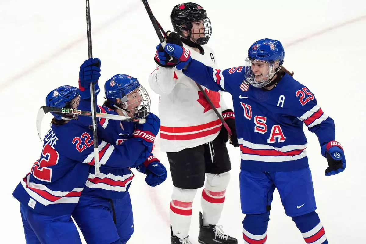 United States' Hilary Knight, second from left, celebrates after scoring a goal against Canada during the third period of the women's ice hockey gold medal game at the 2026 Winter Olympics, in Milan, Italy, Thursday, Feb. 19, 2026. (AP Photo/Carolyn Kaster)